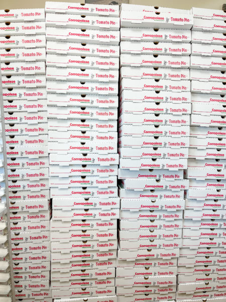 Large stack of Corropolese's tomato pie boxes