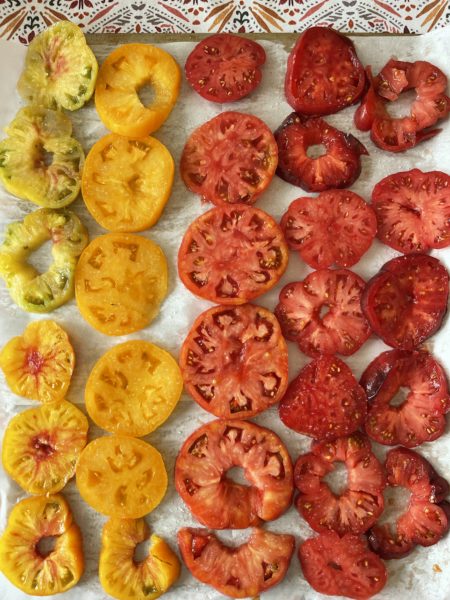 Sliced heirloom tomatoes ranging in color from yellow to red.