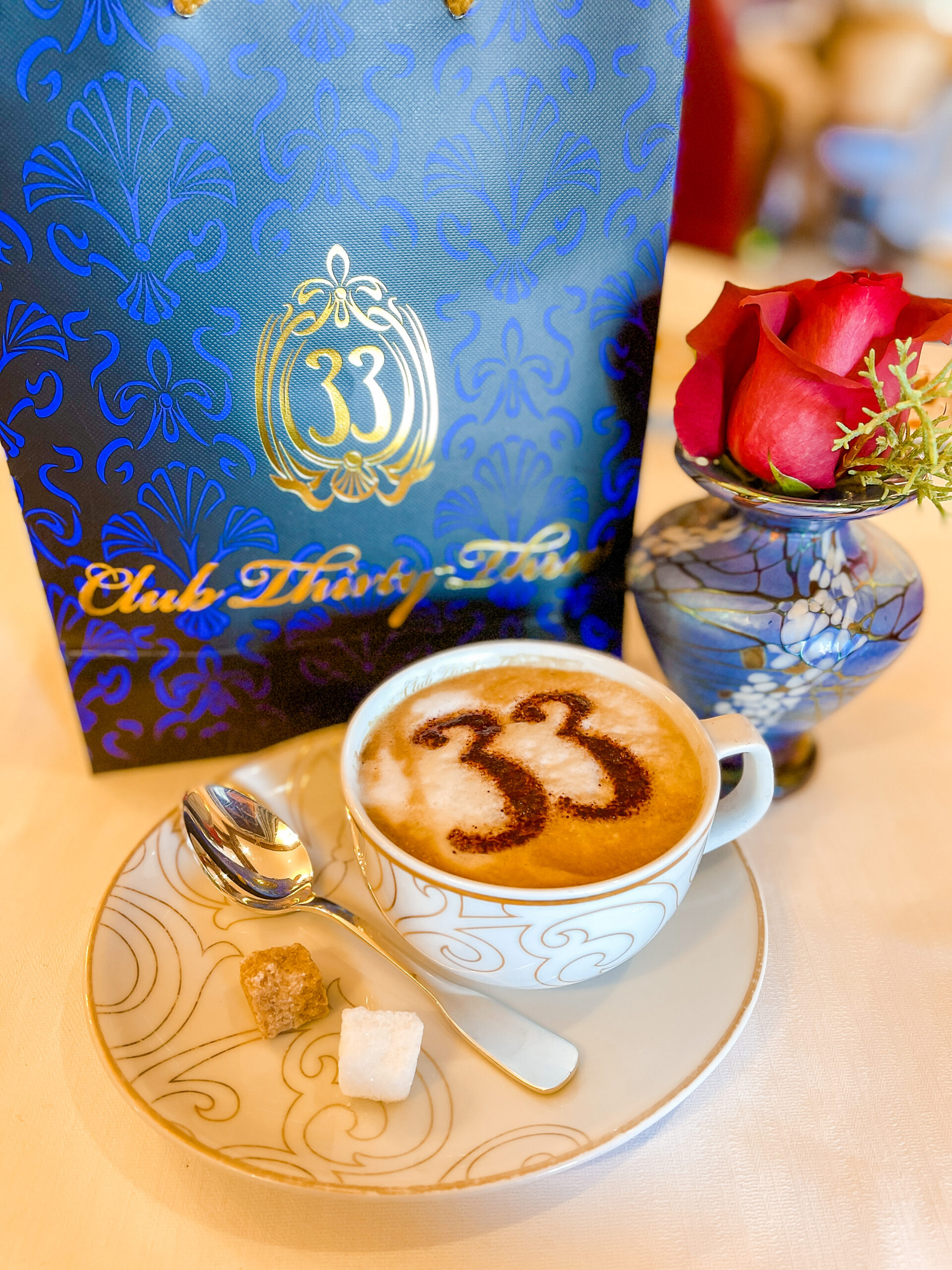 Club logo with Club 33 coffee and rose.