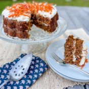 Vegan carrot cake with a slice out of it.