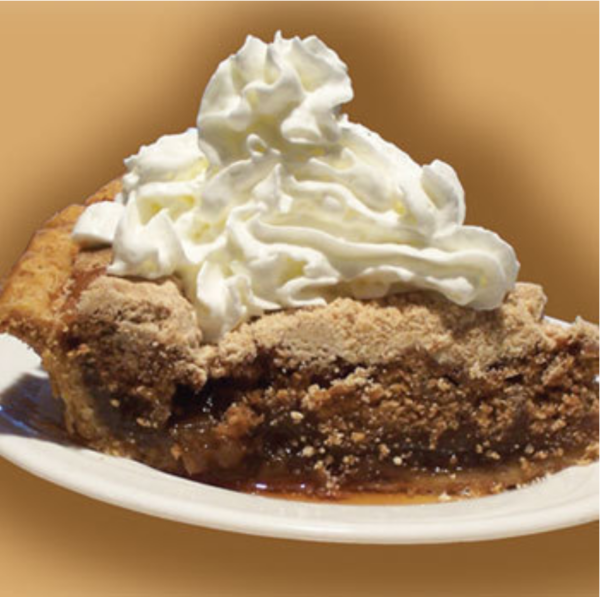 Plate of shoofly pie with whipped cream.