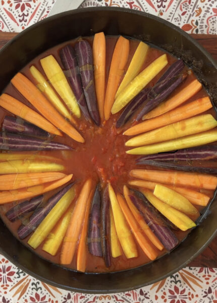 Carrots arranged in circular pan before baking.