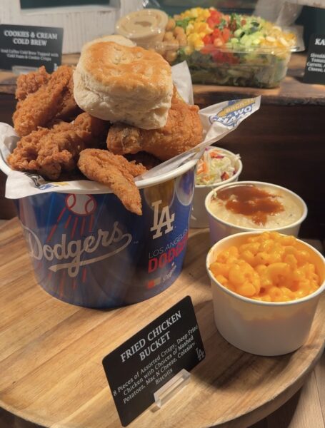Bucket of fried chicken with biscuit and trimmings.