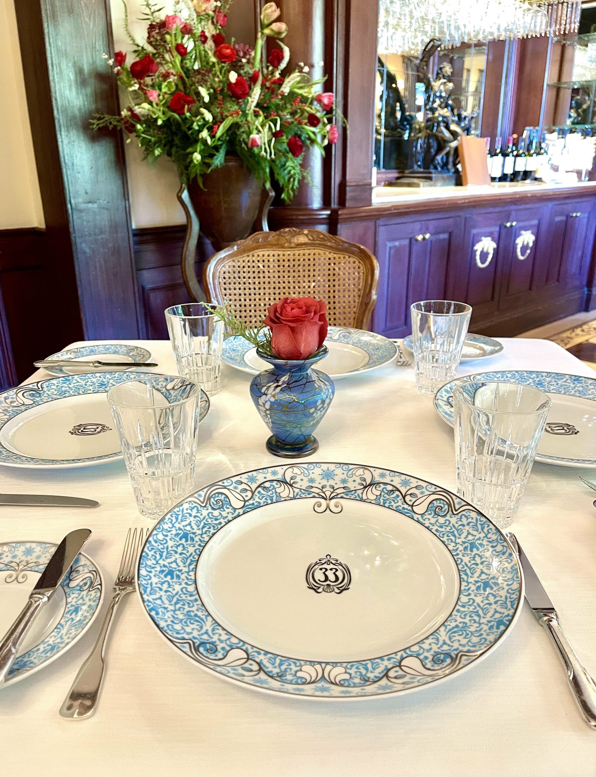 Place setting with rose in Club 33 dining room.