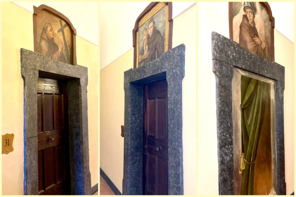 Doorways with paintings of monks overhead at the Hotel Francesco al Monte