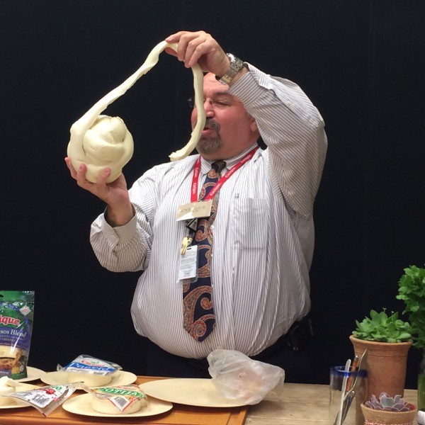 Botello demonstrates how to pull apart the strings on the Oaxaca cheese
