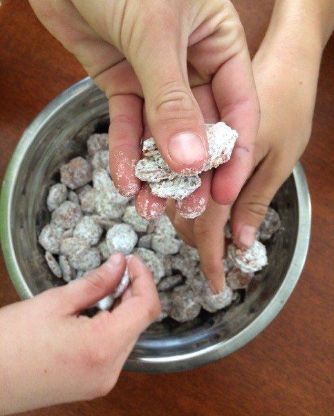 three kids eat puppy chow